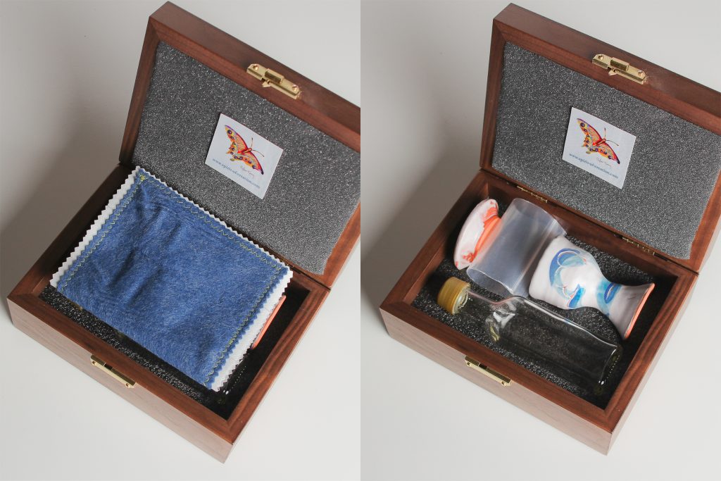 Walnut box (made in USA), custom made to fit the set, with hard foam on the inside bottom of the box, which is carved to hold the set. Soft foam lines the lid and supports the plate to cushion the ceramics for travel.