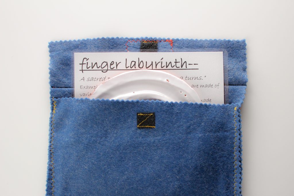 The finger labyrinth set includes a 'meaning of labyrinths' and instruction sheet and handmade cloth bag.